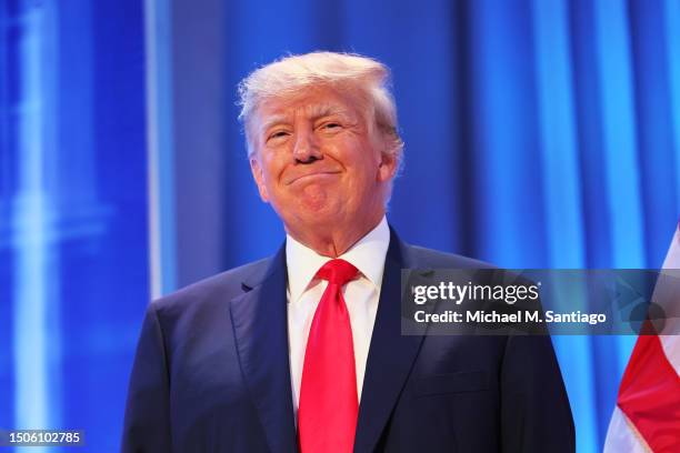 Republican presidential candidate former U.S. President Donald Trump looks at the crowd after taking the stage during the Moms for Liberty Joyful...