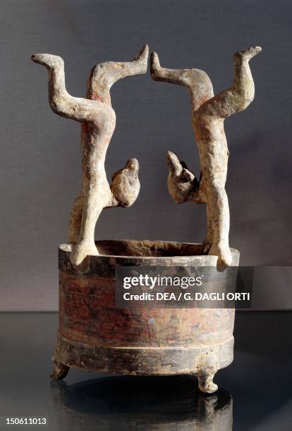 Lian-type vase decorated with two figurines of acrobats, heightened terracotta, China. Chinese Civilisation, Han Dynasty, 3rd century BC-3rd century...