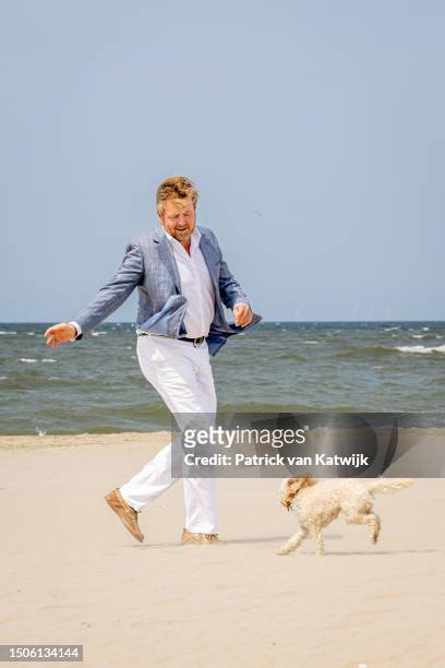 King Willem-Alexander of The Netherlands with his dog Mambo attends the Dutch Royal Family Summer Photocall at Zuiderstrand on June 30, 2023 in The...