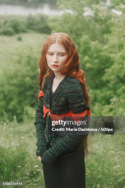 portrait of young woman standing on field,moscow,russia - fashion editorial stock pictures, royalty-free photos & images