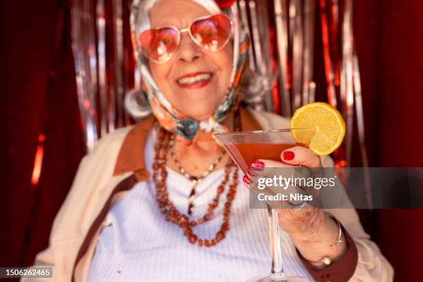 mature woman drinking a cocktail - bloody mary stock pictures, royalty-free photos & images
