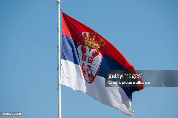 July 2023, Serbia, Belgrad: The national flag of Serbia flies in front of the National Assembly of the Republic of Serbia. Photo: Silas Stein/dpa