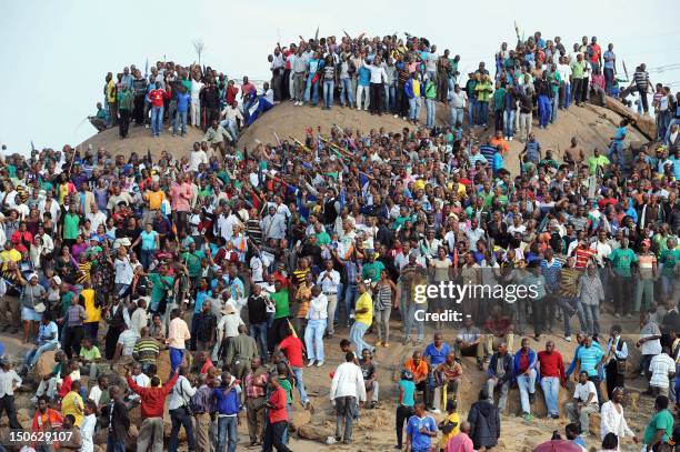 People gather on a hill in Marikana on August 23, 2012 after attending a memorial service for the 44 people killed in a wildcat strike at Lonmin's...