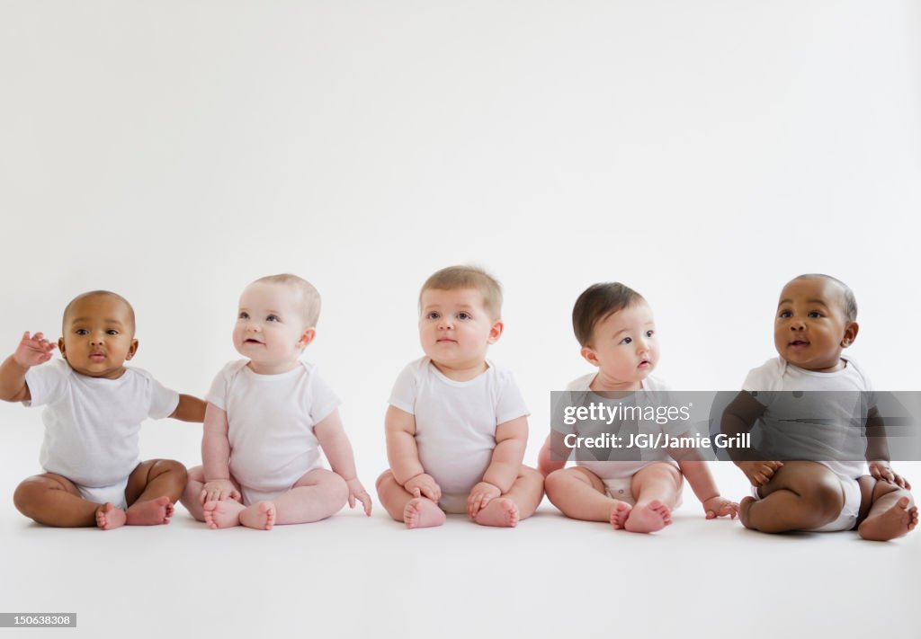 Babies sitting on floor together