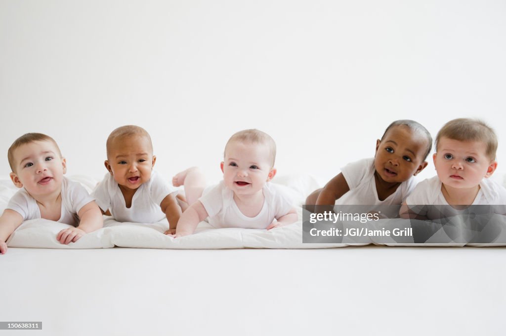 Babies laying on floor together