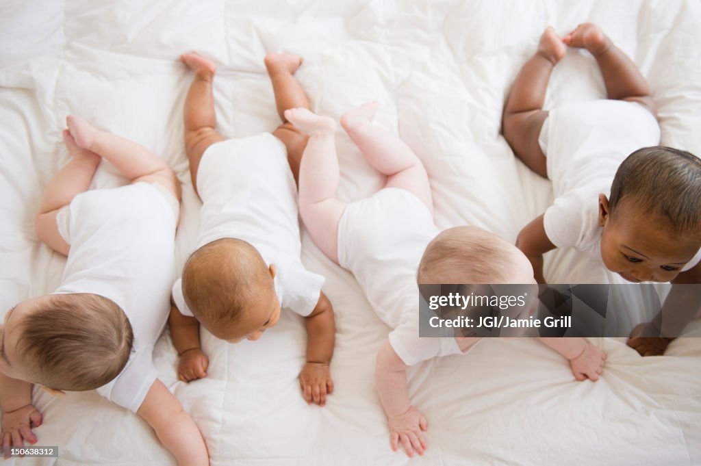 Babies laying on floor together