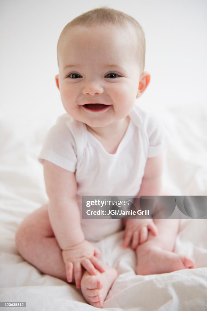 Caucasian baby girl sitting on floor