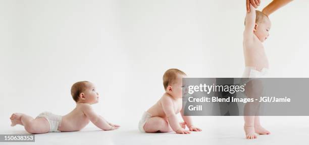 babies laying, sitting and standing together - adult diaper stockfoto's en -beelden