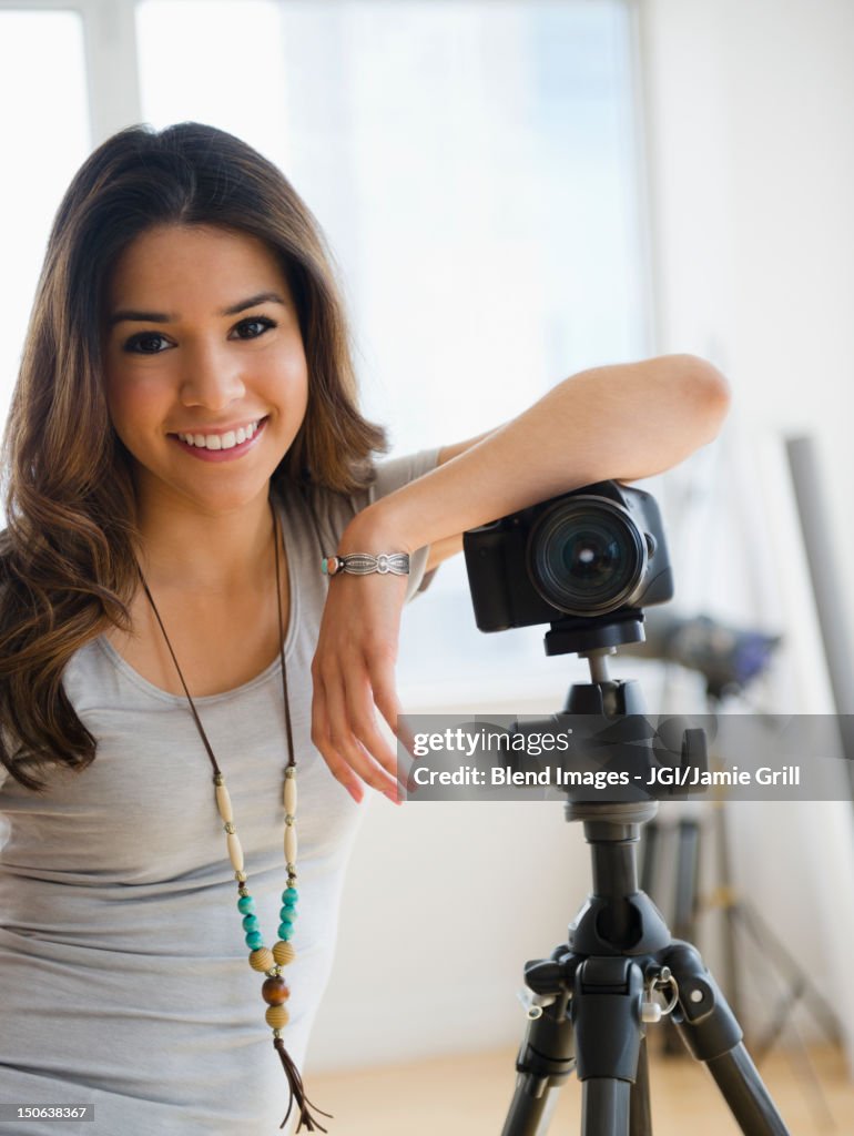 Hispanic woman leaning on camera