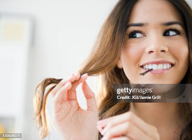 hispanic woman with bobby pins in her mouth - hair pin stock pictures, royalty-free photos & images