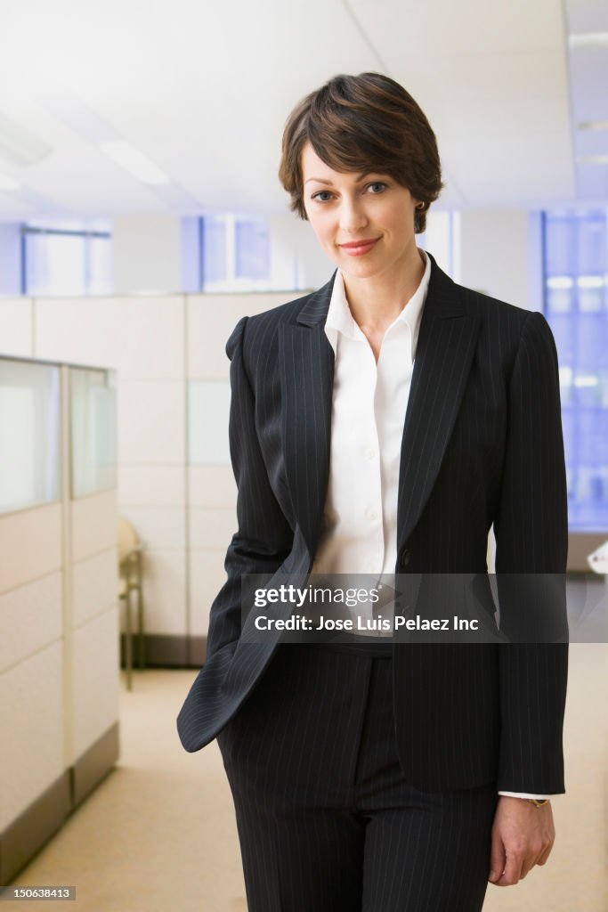Caucasian businesswoman standing in office