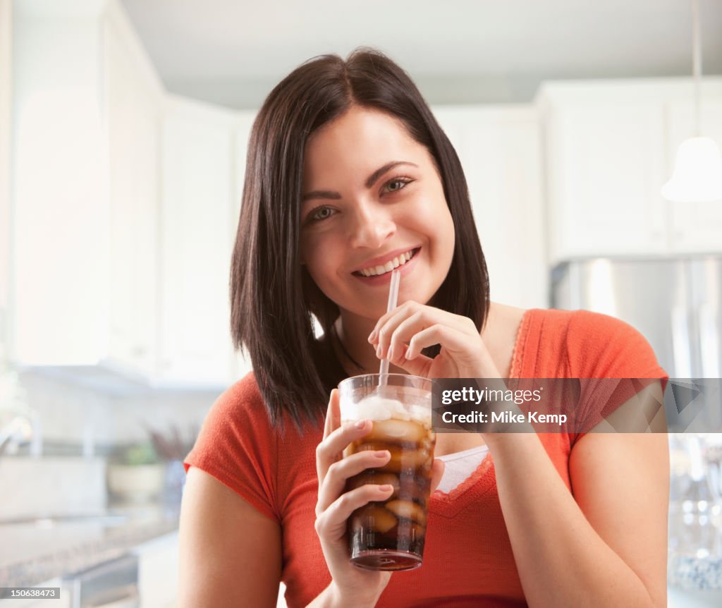 Caucasian woman drinking soda