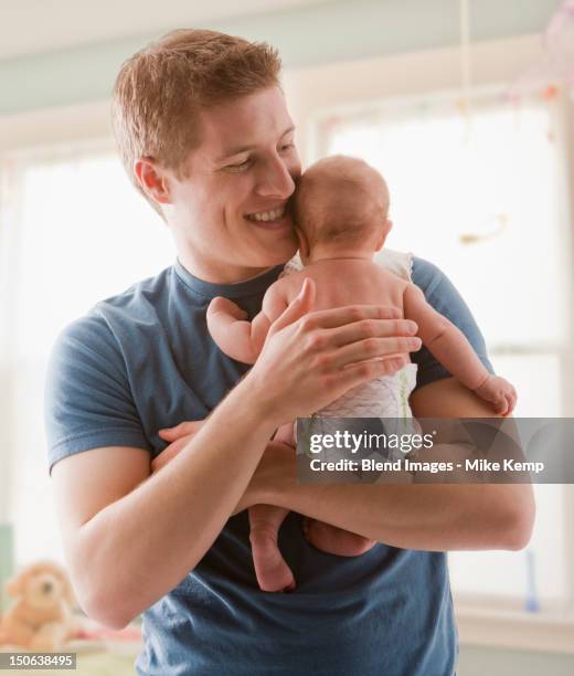caucasian father holding baby girl - man wearing diaper stock pictures, royalty-free photos & images