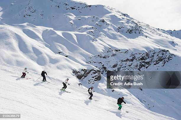 skiers skiing together on slope - bormio stock pictures, royalty-free photos & images