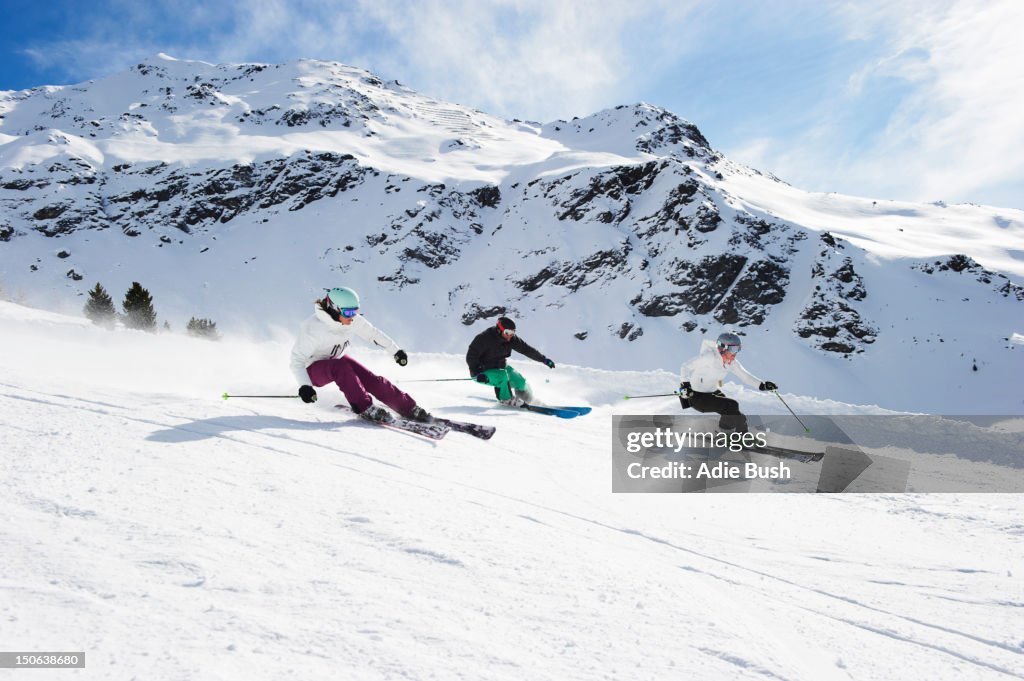Skiers skiing together on slope