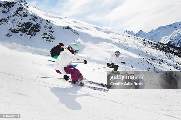 skiers skiing together on slope - lombardei stock-fotos und bilder