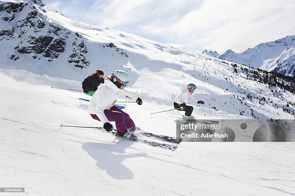 Skiers skiing together on slope