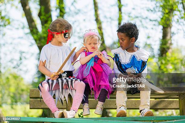 children playing dress up outdoors - princess pirates stock pictures, royalty-free photos & images