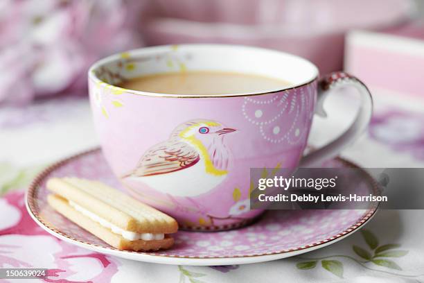 close up of cup of tea and cookie - tea stock pictures, royalty-free photos & images