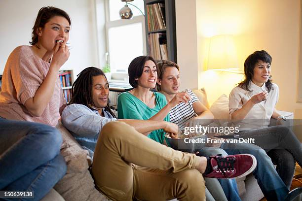 Friends Watching A Movie In Living Room, Foto de stock