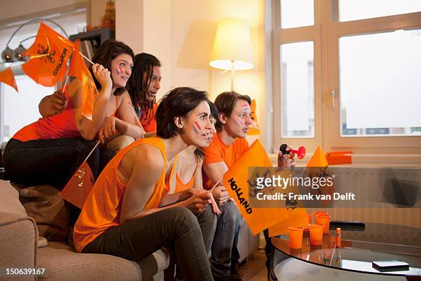 friends watching sports on television - orange stock pictures, royalty-free photos & images