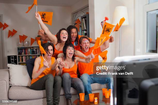 friends watching sports on television - cheering stock pictures, royalty-free photos & images