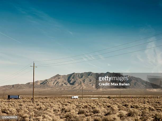 power lines, dirt road and mountain - nevada stock pictures, royalty-free photos & images