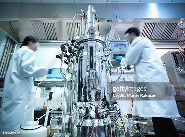 scientists working in protein production where cells and culture samples are created in a bioreactor - healthcare complexity stock pictures, royalty-free photos & images