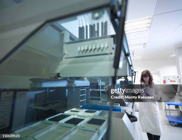 scientist using a dna sequencer to create automated samples in biolab - genetic research stock pictures, royalty-free photos & images