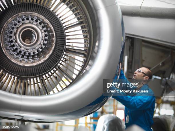 aircraft engineer working on 737 jet engine in airport - flair airlines stock pictures, royalty-free photos & images