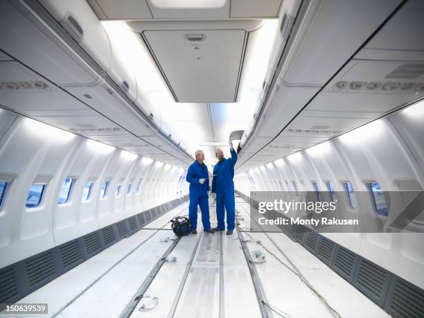 aircraft engineers working on interior of 737 jet airplane - flugzeugtriebwerk stock-fotos und bilder