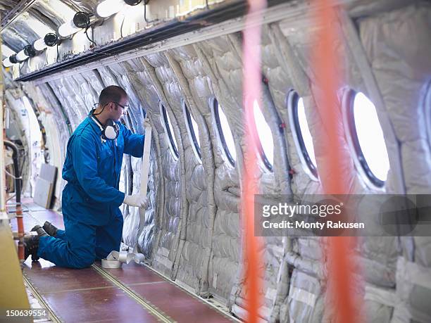 Aircraft engineer working on interior of 737 jet airplane