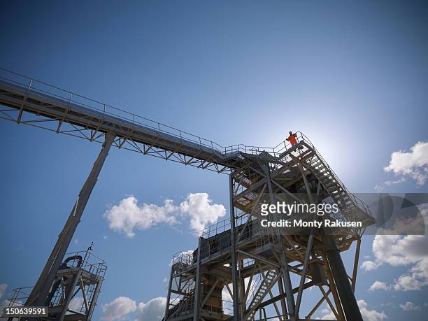 workman standing on stone screening and crushing machine in quarry - screening of england is mine stock pictures, royalty-free photos & images