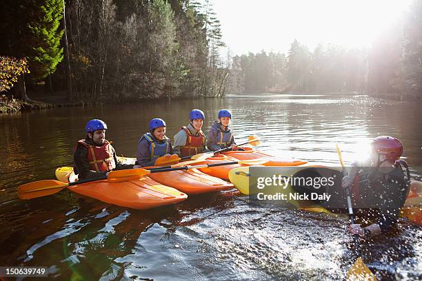 teacher capsizing kayak in still lake - life jacket isolated stock pictures, royalty-free photos & images