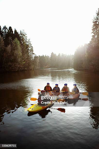 teacher talking to students in kayaks - boat helm stock pictures, royalty-free photos & images