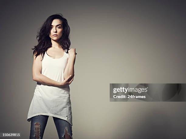 woman posing with gray background - touching elbows stock pictures, royalty-free photos & images