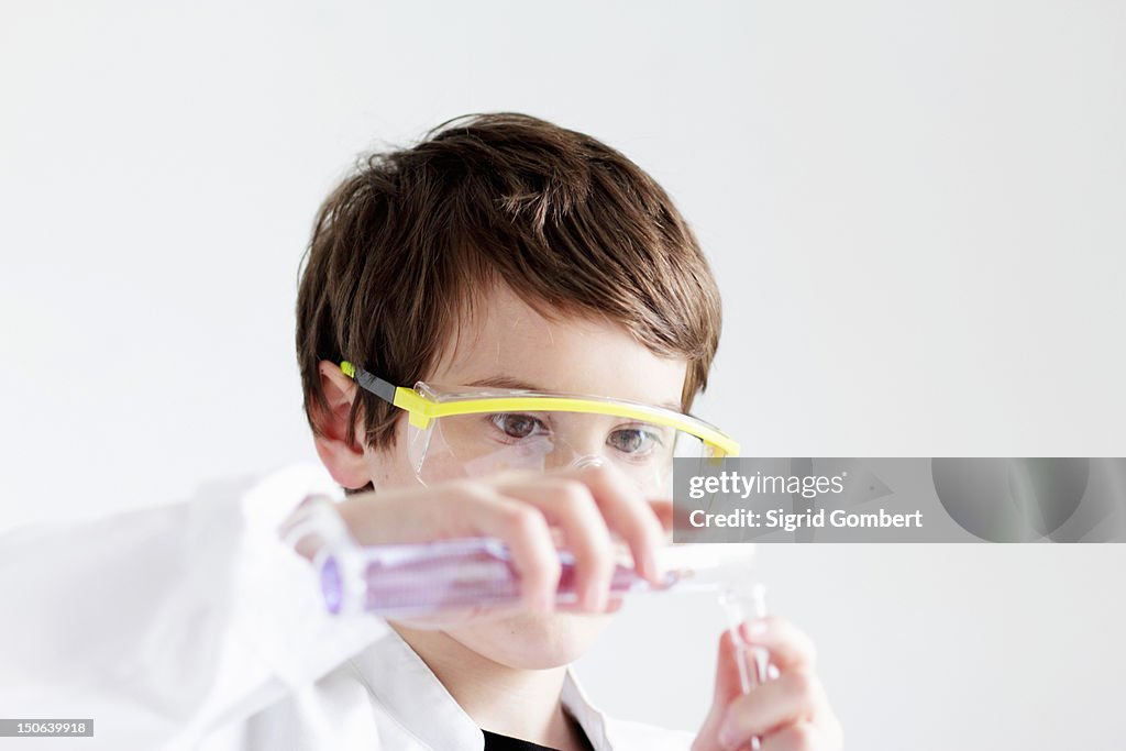Student pouring liquid into test tubes