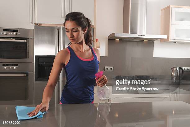 woman cleaning kitchen counter - rubbing stock pictures, royalty-free photos & images