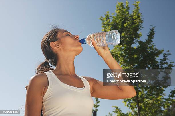 woman drinking water outdoors - hot spanish women stock pictures, royalty-free photos & images