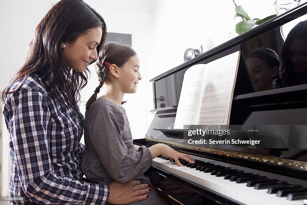 Mother and daughter sitting at piano