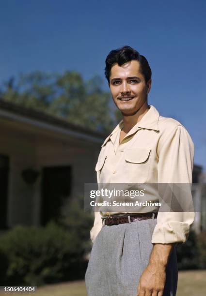 American actor and filmmaker, John Derek in a promotional portrait, 1950.