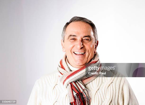 happy senior man in winter clothes, portrait - halstuch stock-fotos und bilder