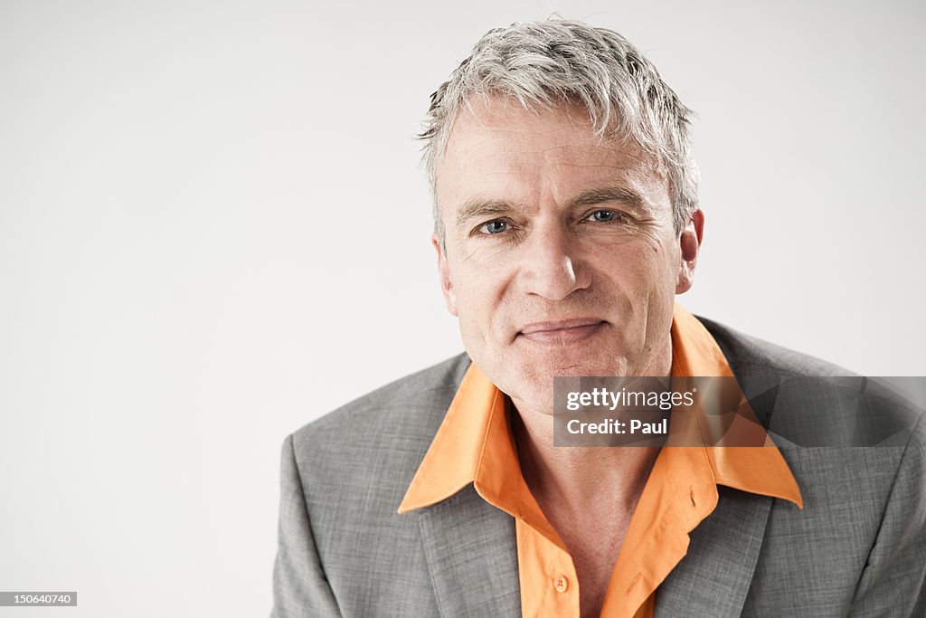 Confident mature man wearing gray jacket