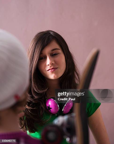 teenage girl looking at boy with skateboard - skater boy hair stock pictures, royalty-free photos & images