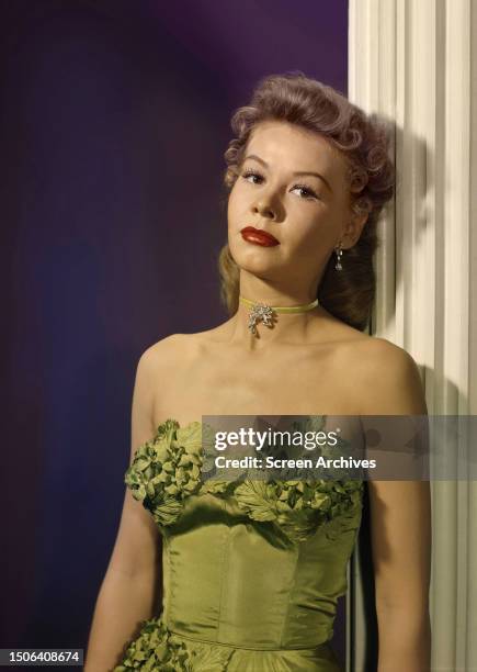 American dancer and actress Vera-Ellen portrait in an off-the-shoulder green dress, circa 1947.