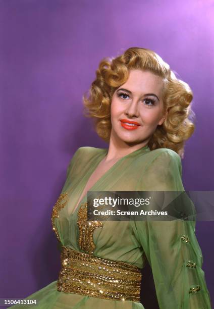 American actress Marilyn Maxwell wearing a green dress, circa 1950.