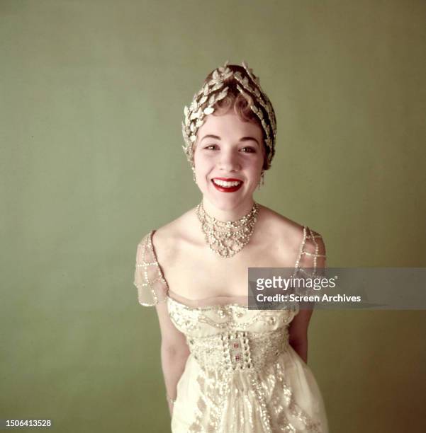 English actress and singer Julie Andrews wearing her ballgown from the stage musical 'My Fair Lady', circa 1956.