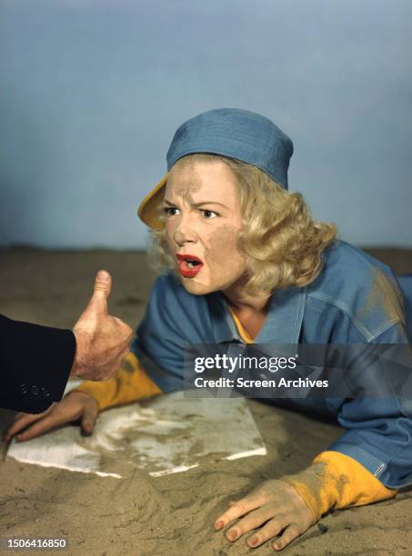 American actress Betty Hutton in overalls with sand on her face, circa 1945.