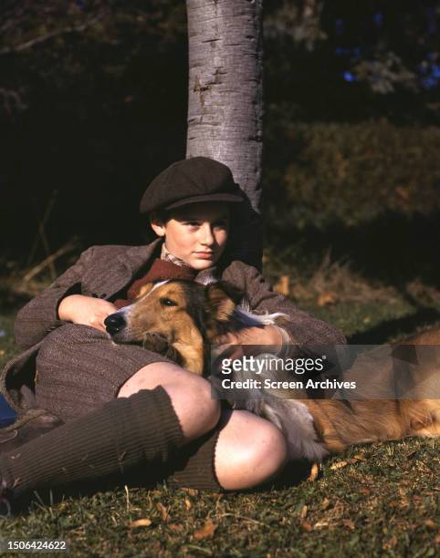 British and American actor Roddy McDowall with the rough Collie dog, Pal, in a promotional portrait for the 1943 MGM movie 'Lassie Come Home'.