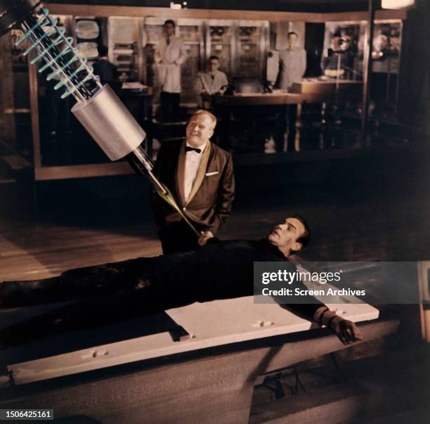 Sean Connery as James Bond is tied to table as Gert Frobe watches a laser beam get ever closer to the secret agent in a scene from 'Goldfinger', 1964.